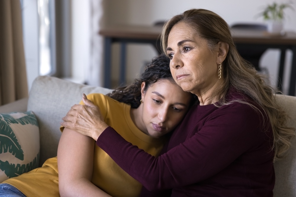 Mother comforting her daughter with mental health issues