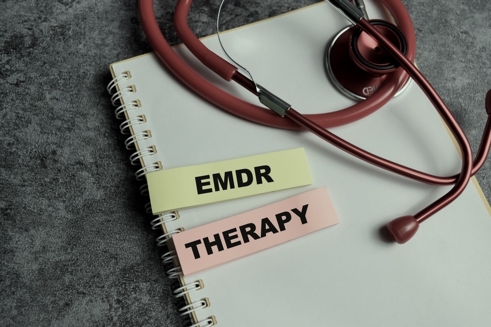 Notebook with EMDR Therapy and stethoscope